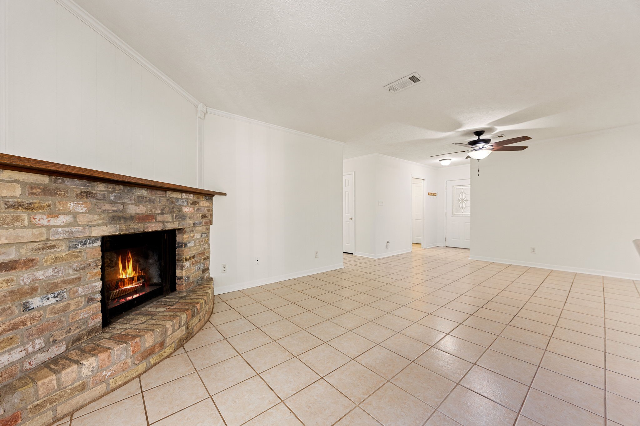 113 Hillendale Street Livingston, TX 77351 - Photo 7 of 47 Cozy brick fireplace creating a warm focal point for the living space.