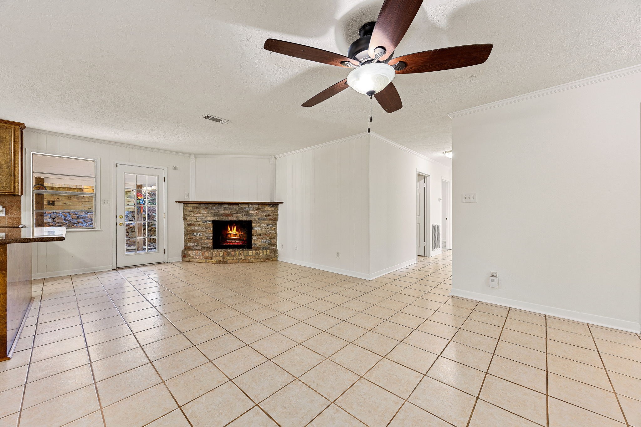 113 Hillendale Street Livingston, TX 77351 - Photo 9 of 47 Generous living space with fireplace and access to the main areas of the home.