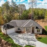 a view of house with backyard