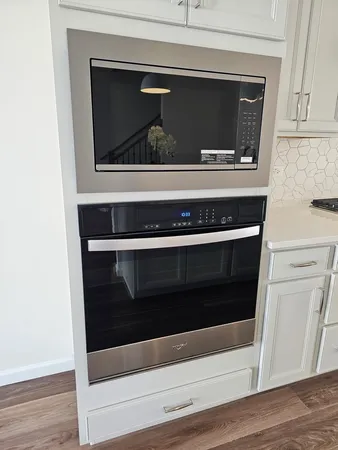 a stove top oven sitting inside of a kitchen