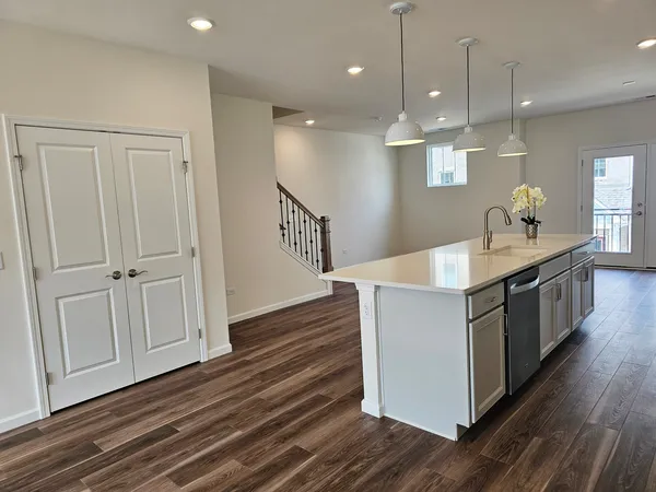 a kitchen with kitchen island white cabinets and sink