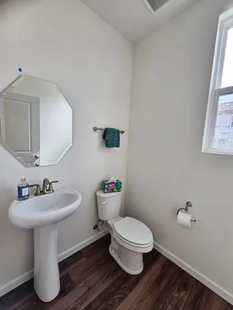 a bathroom with a sink toilet and a mirror