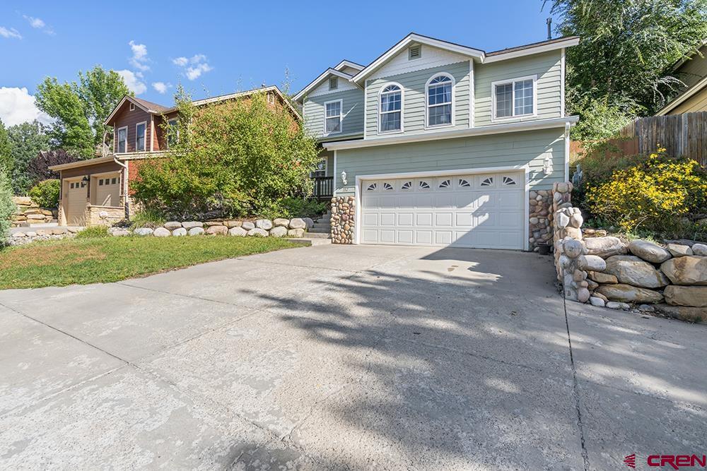 332 Jenkins Ranch Road Durango, CO 81301 - Photo 1 of 34 a front view of a house with a yard and garage