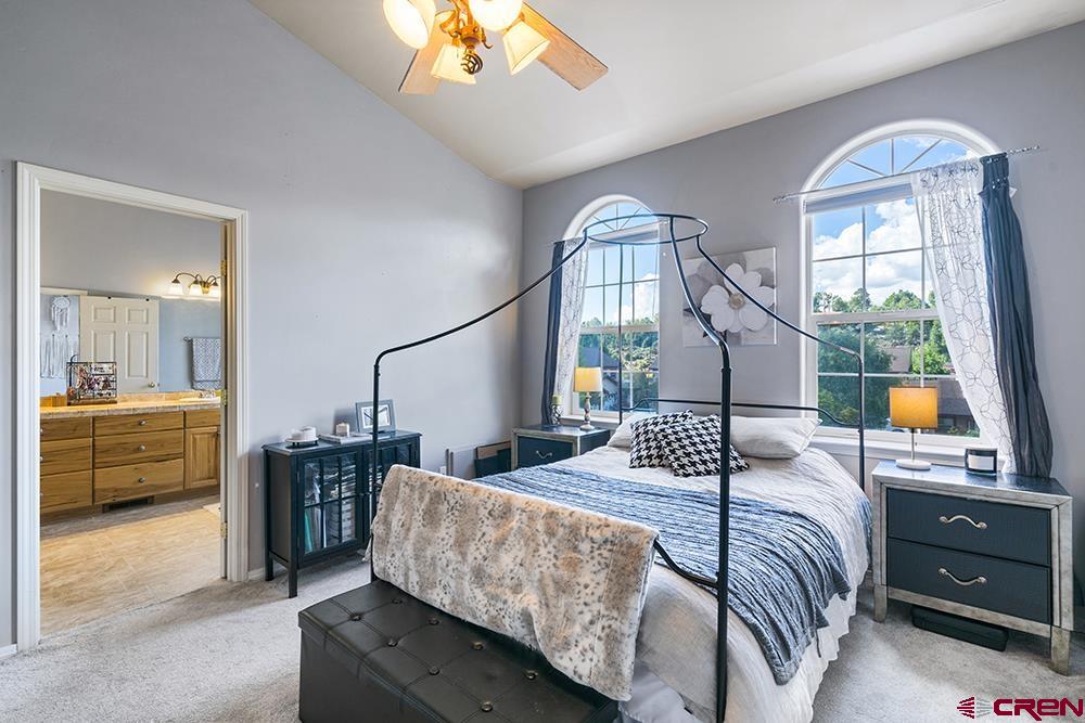332 Jenkins Ranch Road Durango, CO 81301 - Photo 13 of 34 a bedroom with a large bed and a chandelier