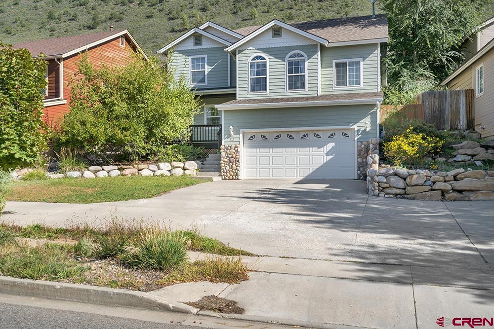 332 Jenkins Ranch Road Durango, CO 81301 - Photo 34 of 34 a front view of a house with a yard and garage