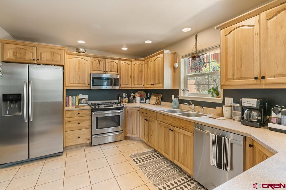 332 Jenkins Ranch Road Durango, CO 81301 - Photo 8 of 34 a kitchen with stainless steel appliances a refrigerator sink and cabinets