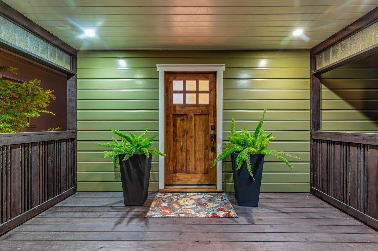 a view of a entryway door front of house with wooden floor