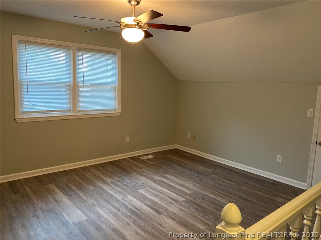 1734 Rim Road Fayetteville, NC 28314 - Photo 17 of 24 a view of an empty room with wooden floor and a window