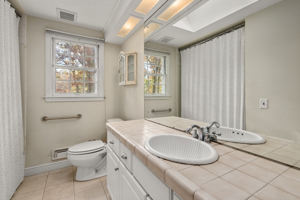154 Fairview Avenue Rehoboth, MA 02769 - Photo 20 of 25 a bathroom with a granite countertop sink toilet and a mirror