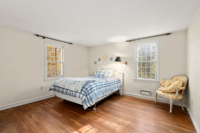 a bedroom with a bed and chair