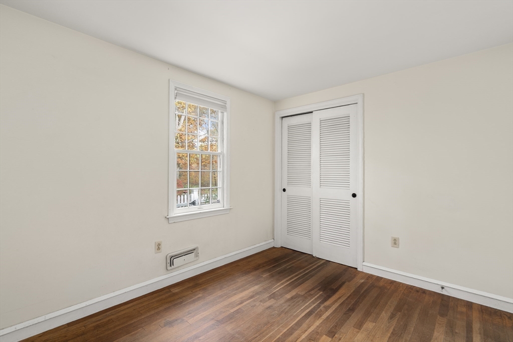 154 Fairview Avenue Rehoboth, MA 02769 - Photo 23 of 25 an empty room with wooden floor and windows