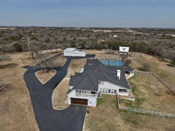 an aerial view of a house with outdoor space
