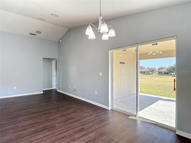a kitchen with granite countertop stainless steel appliances white cabinets granite counter tops and a wooden floors