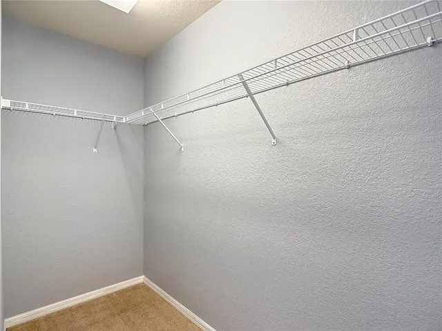 a view of an empty room with a ceiling fan