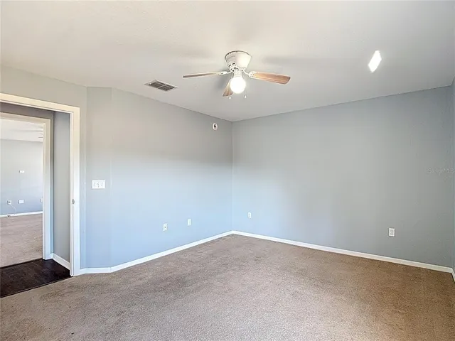 a bathroom with a granite countertop sink a toilet and a mirror