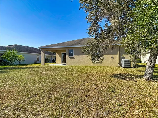 an aerial view of a house with a lake view