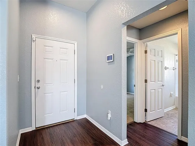 a view of a room with wooden floor and fan