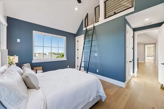 a bathroom with a toilet sink vanity and mirror
