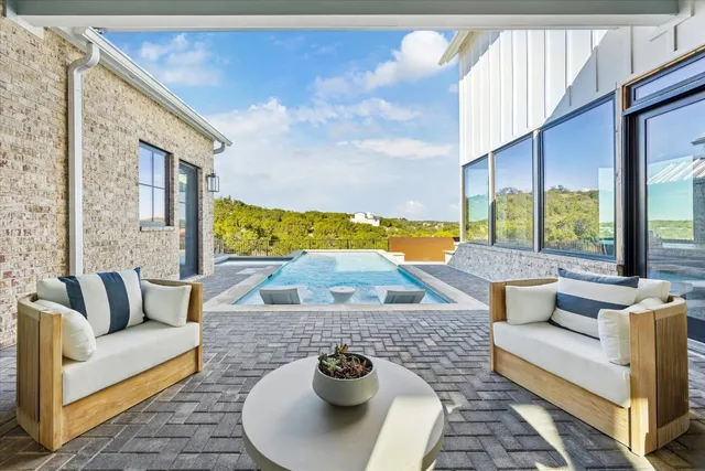 a living room with furniture and a floor to ceiling window