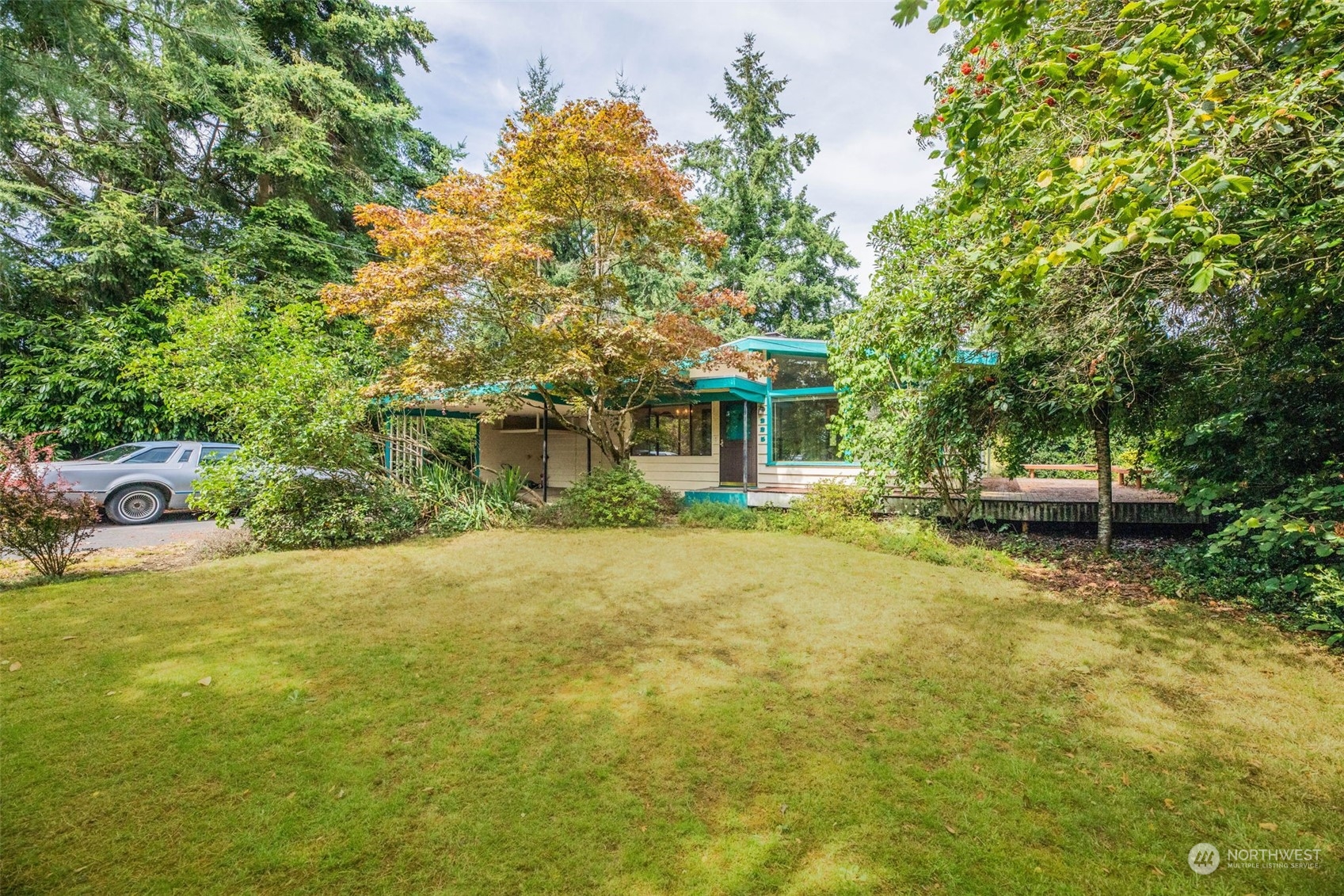225 76th Street Southwest Everett, WA 98203 - Photo 1 of 26 a front view of a house with a yard and trees