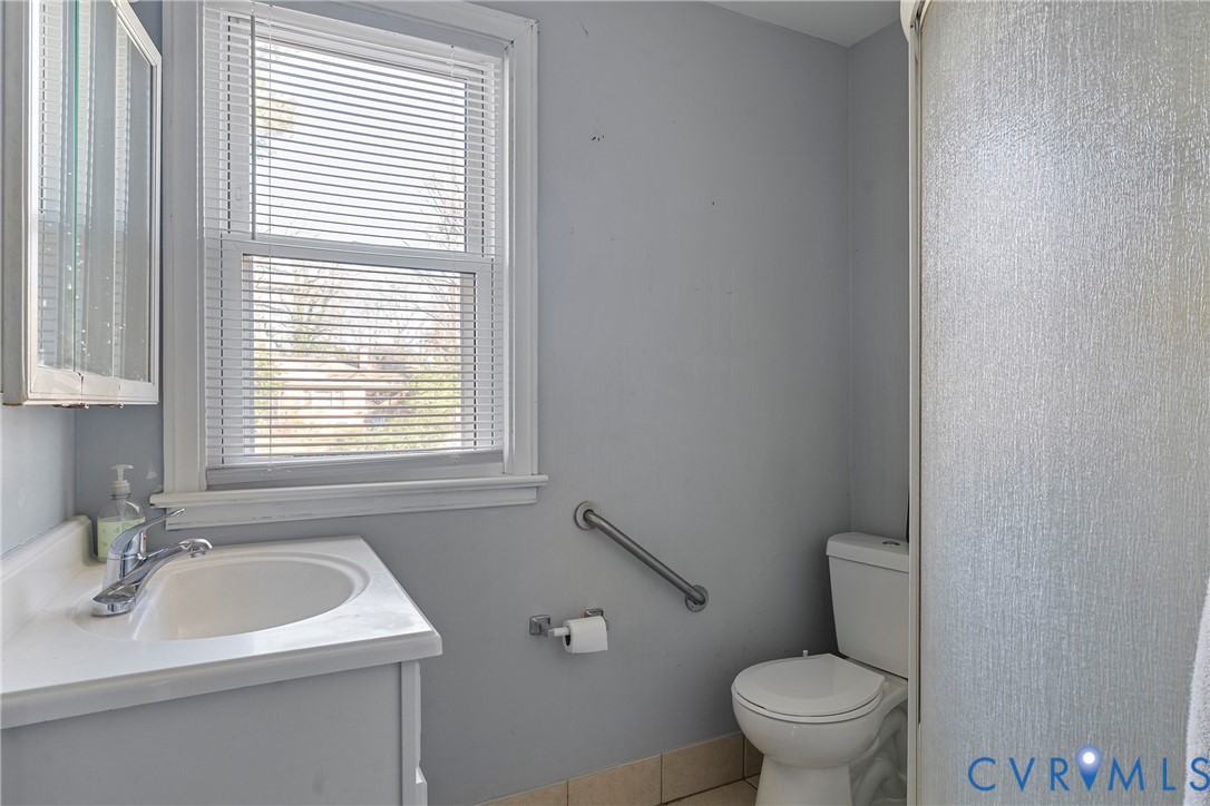 1408 Boroughbridge Road Richmond, VA 23225 - Photo 22 of 31 a bathroom with a sink a toilet and a window
