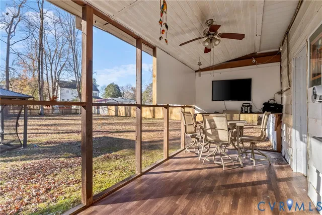 a view of a living room and balcony with furniture