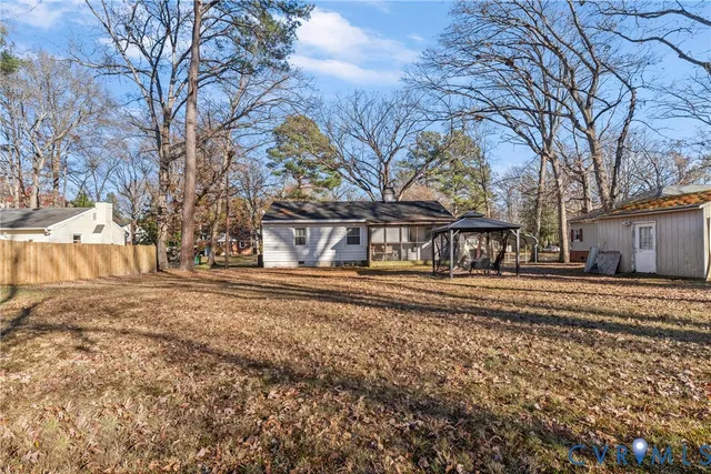 a view of a house with trees in the background