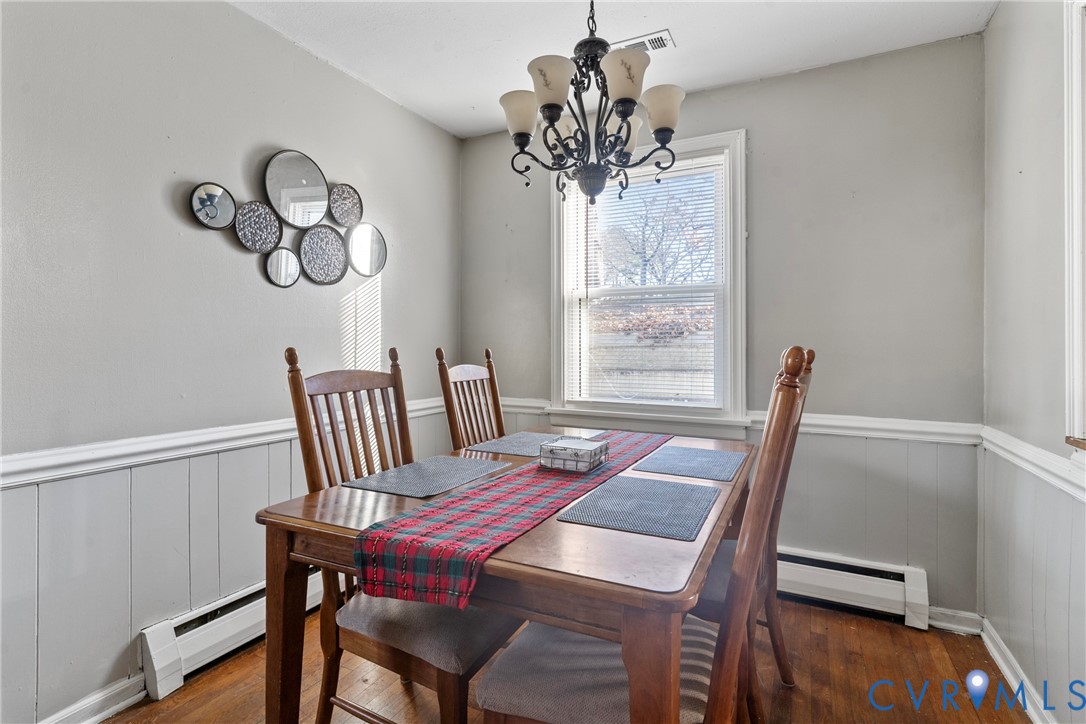 1408 Boroughbridge Road Richmond, VA 23225 - Photo 10 of 31 a view of a dining room with furniture a chandelier and wooden floor