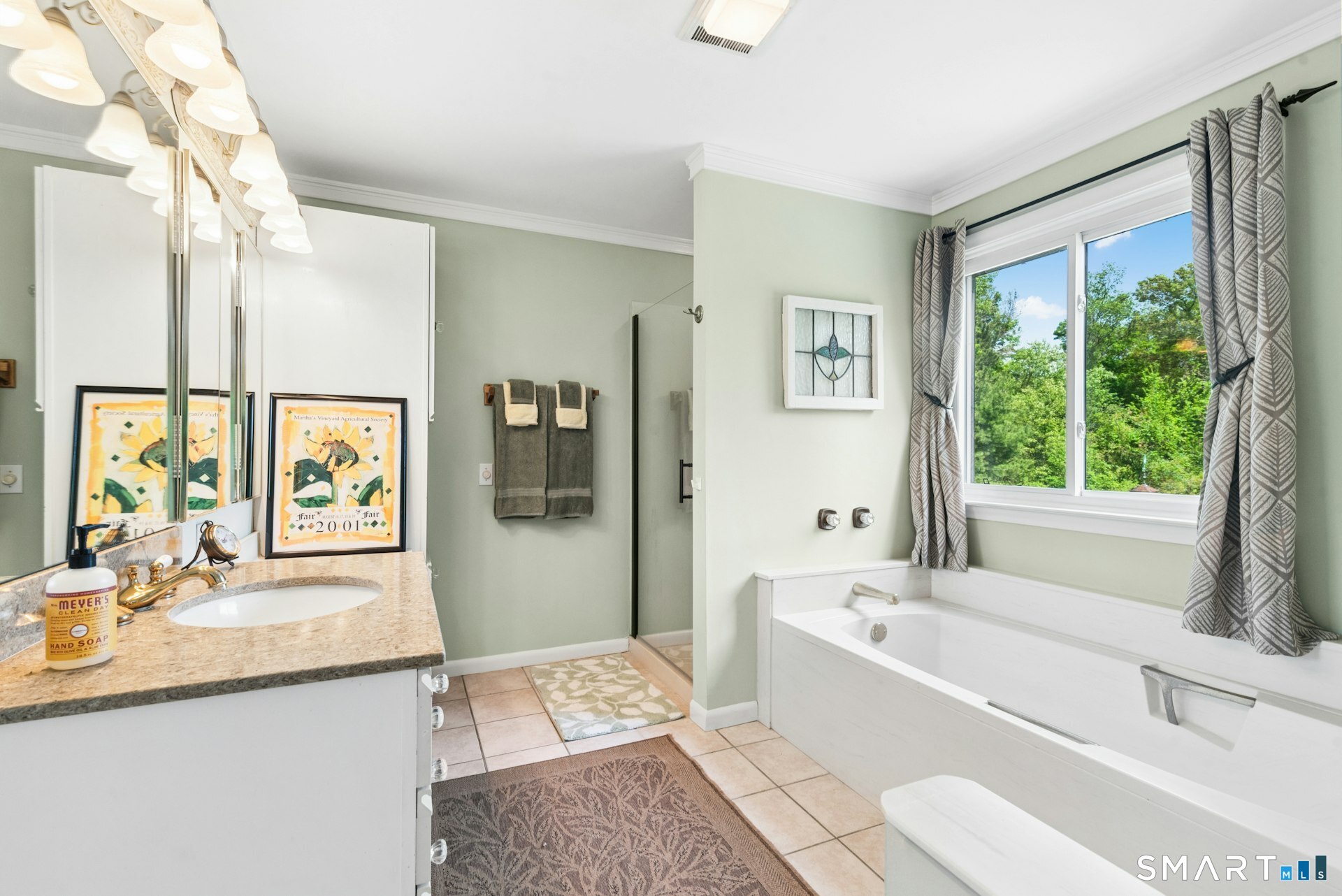 127 Huntingtown Road Newtown, CT 06470 - Photo 19 of 38 a bathroom with a granite countertop sink a large mirror a bathtub and next to a window