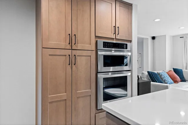 a kitchen with stainless steel appliances a refrigerator and cabinets