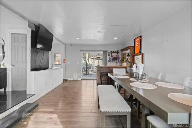 a view of a dining room with furniture a kitchen and chandelier