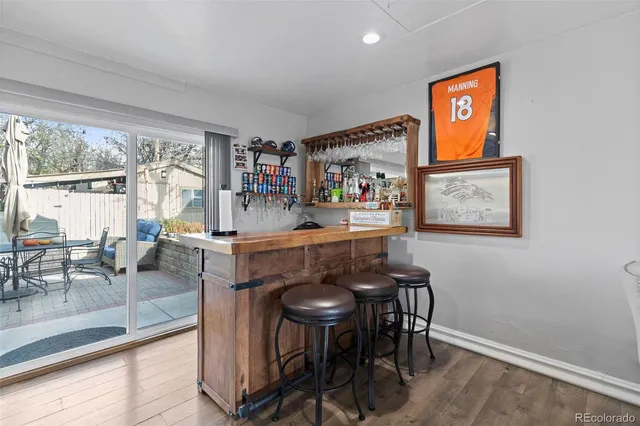 a dining room with furniture and a floor to ceiling window