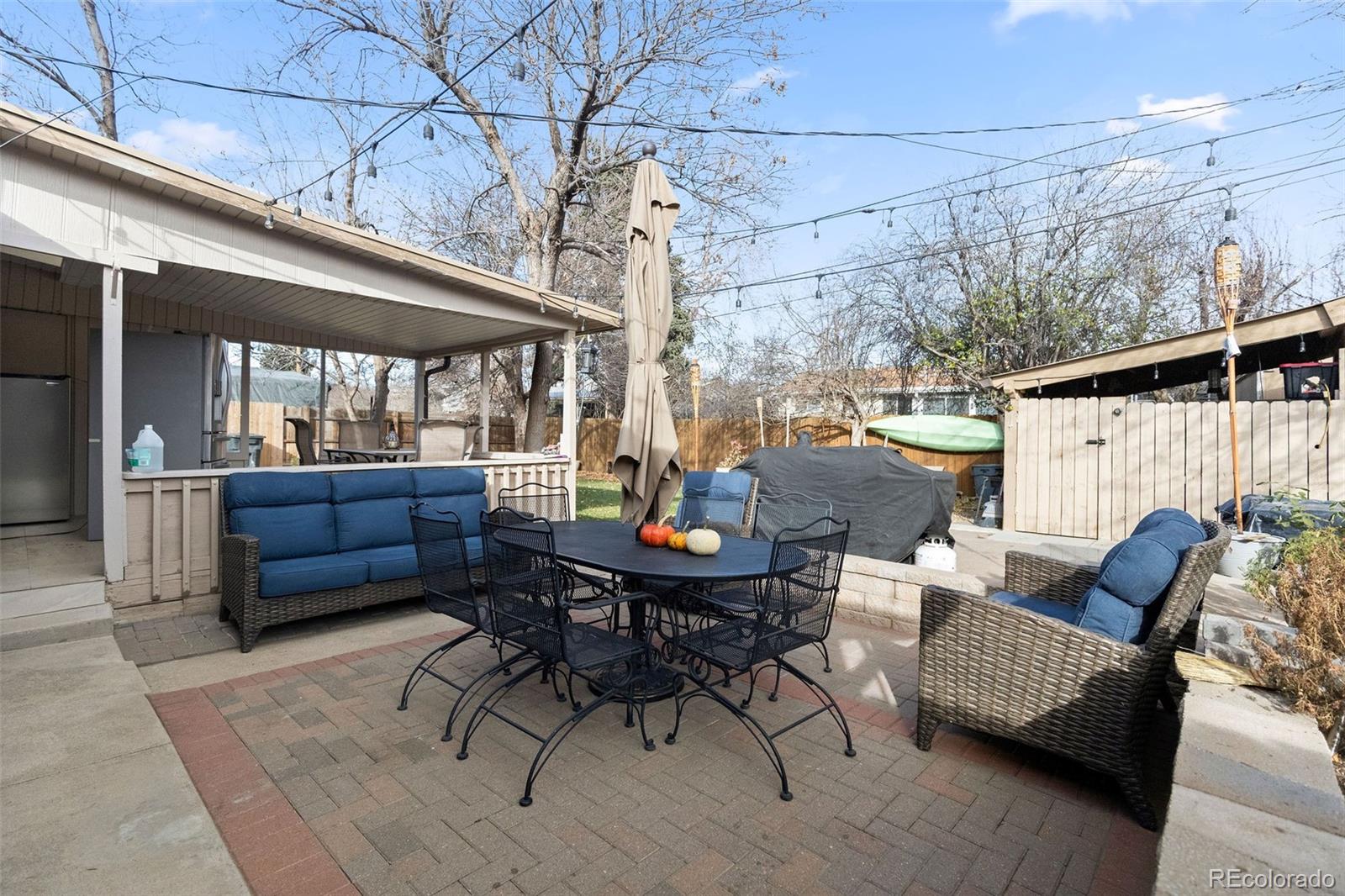 642 South Racine Street Aurora, CO 80012 - Photo 31 of 36 a outdoor space with a couch and wooden floor