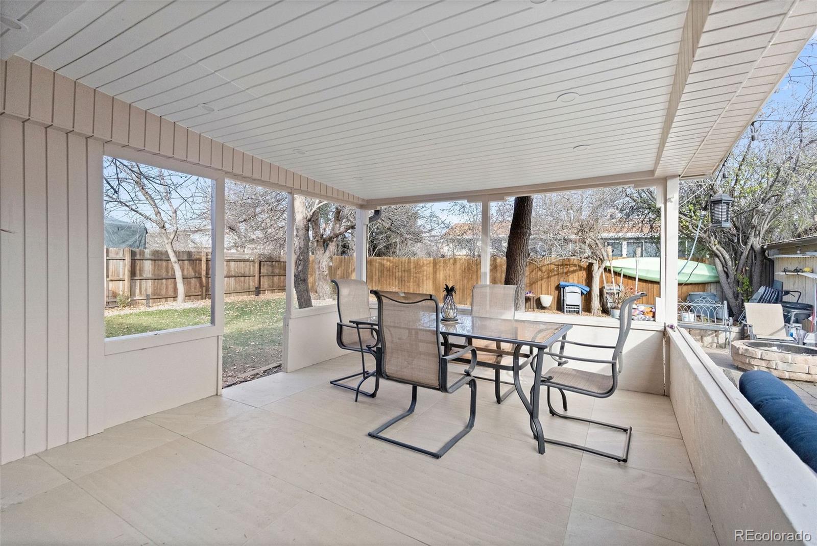 642 South Racine Street Aurora, CO 80012 - Photo 32 of 36 a dining room with furniture and large windows