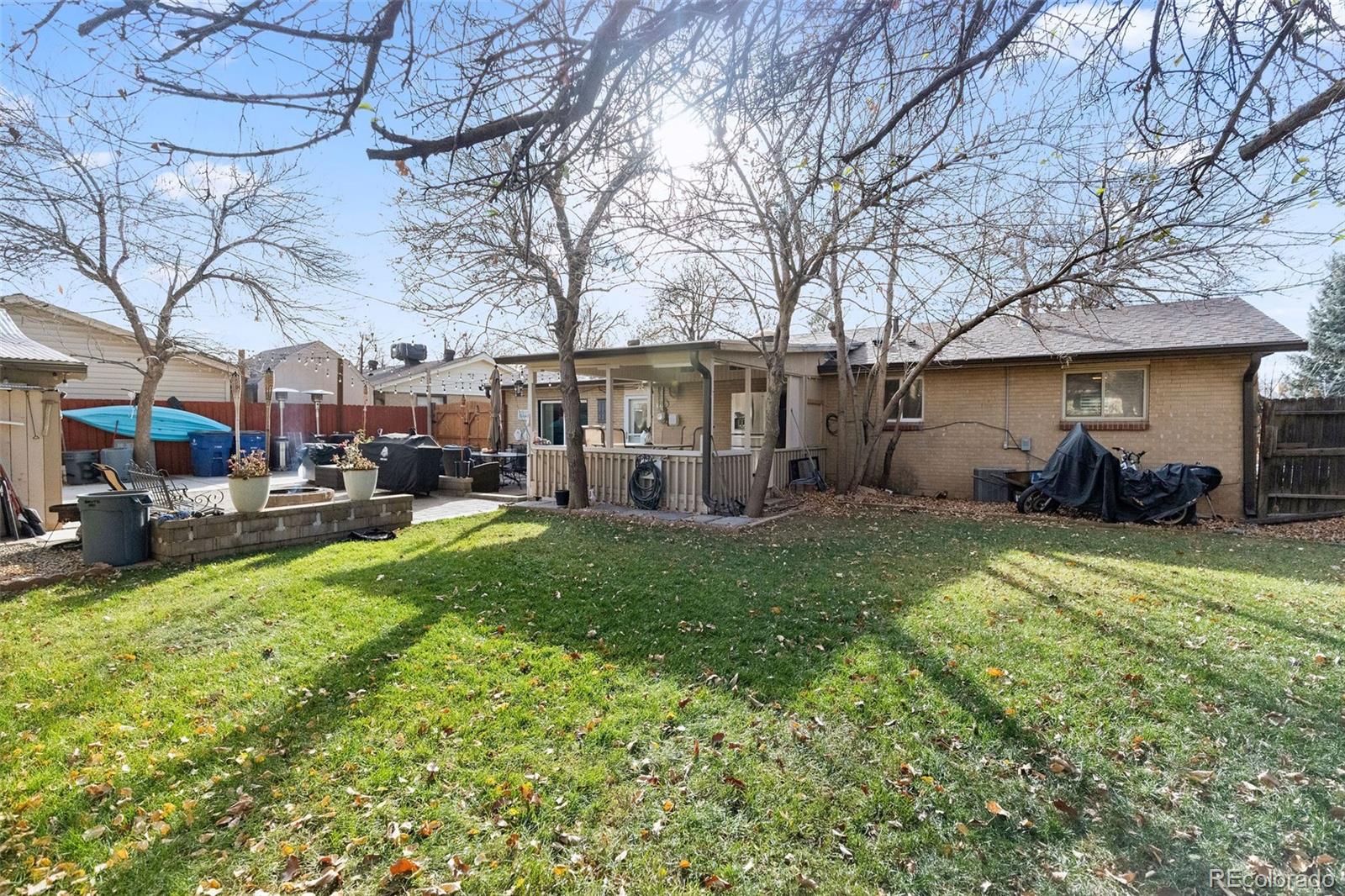 642 South Racine Street Aurora, CO 80012 - Photo 34 of 36 a view of a yard with table and chairs under an umbrella