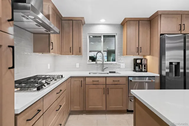 a kitchen with cabinets appliances and a counter