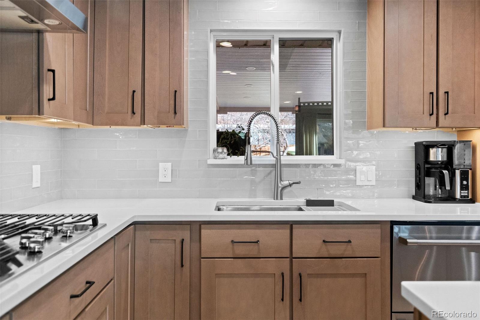 642 South Racine Street Aurora, CO 80012 - Photo 8 of 36 a kitchen with stainless steel appliances granite countertop a sink stove and cabinets