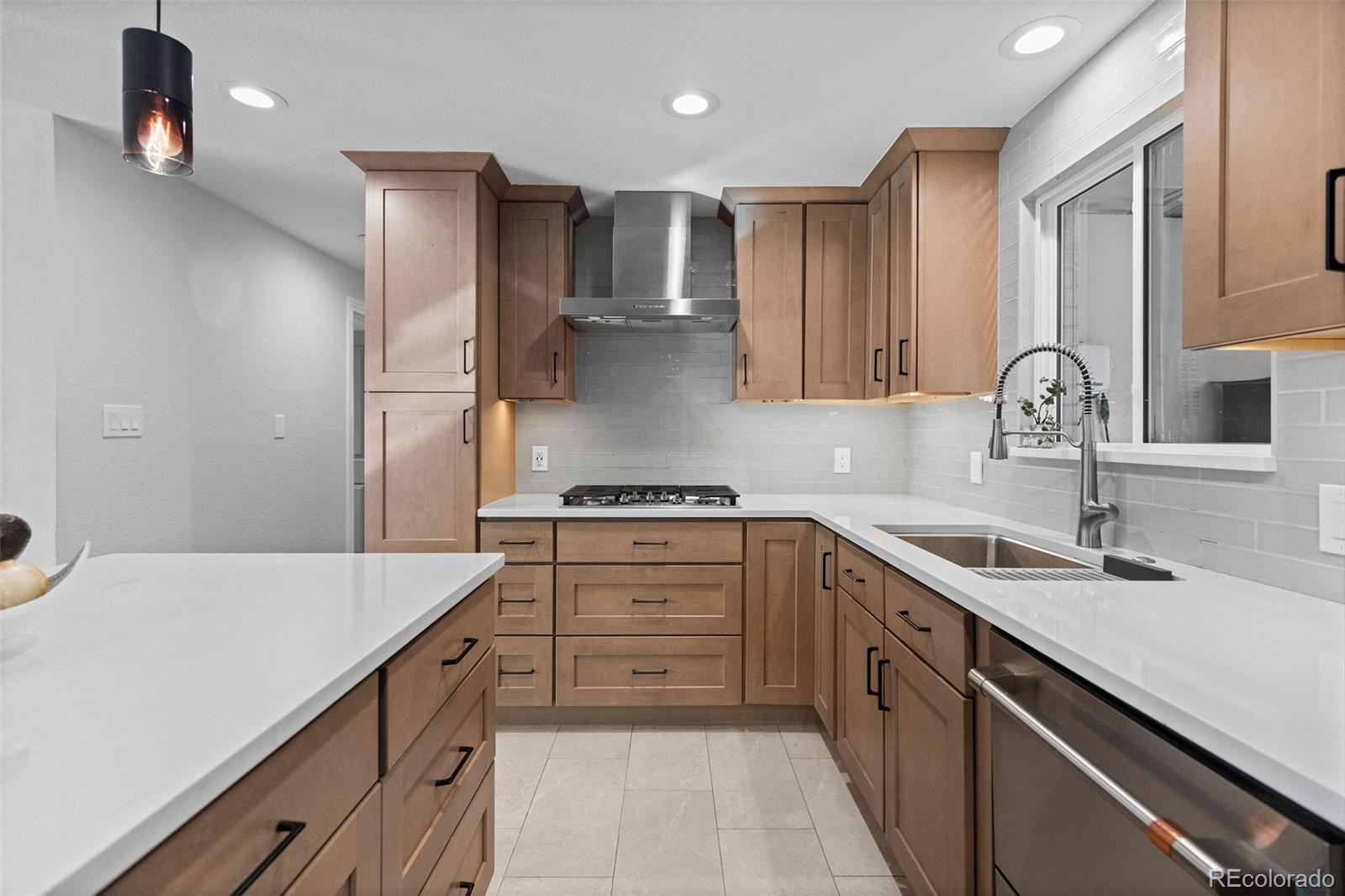 642 South Racine Street Aurora, CO 80012 - Photo 9 of 36 a kitchen with a sink dishwasher a stove and a refrigerator with wooden floor