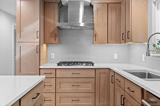 a kitchen with cabinets appliances and a sink