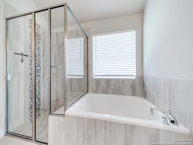 a bathroom with a bathtub and a shower