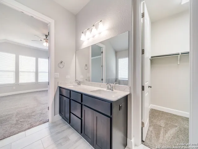a bathroom with a double vanity sink and a mirror