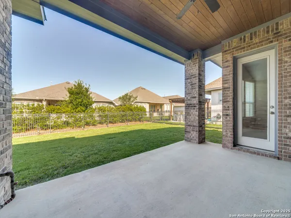 a view of a house with backyard and porch