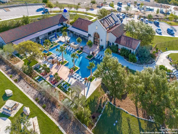 an aerial view of a resort with swimming pool and ocean view