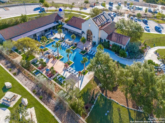an aerial view of a resort with swimming pool and ocean view