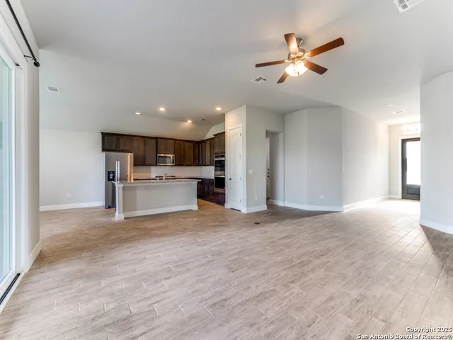 a view of a kitchen with a sink cabinets and wooden floor