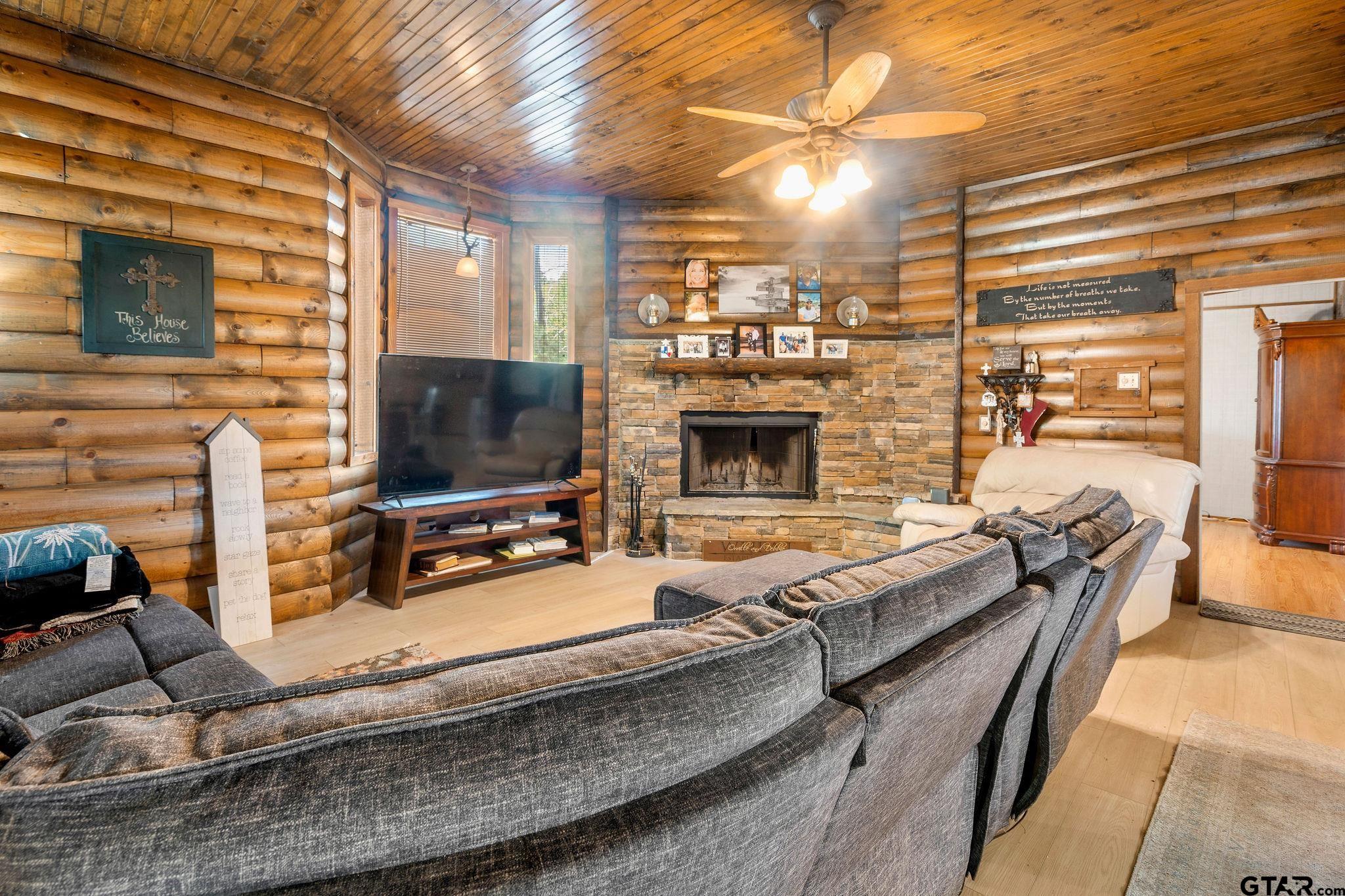 4550 Crabapple Road Gilmer, TX 75645 - Photo 20 of 33 a living room with furniture flat screen tv and a fireplace