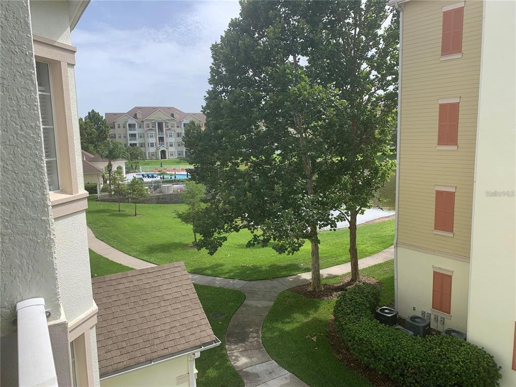5255 Cane Island Loop, Unit 304 Kissimmee, FL 34746 - Photo 2 of 14 a view of a porch with a yard