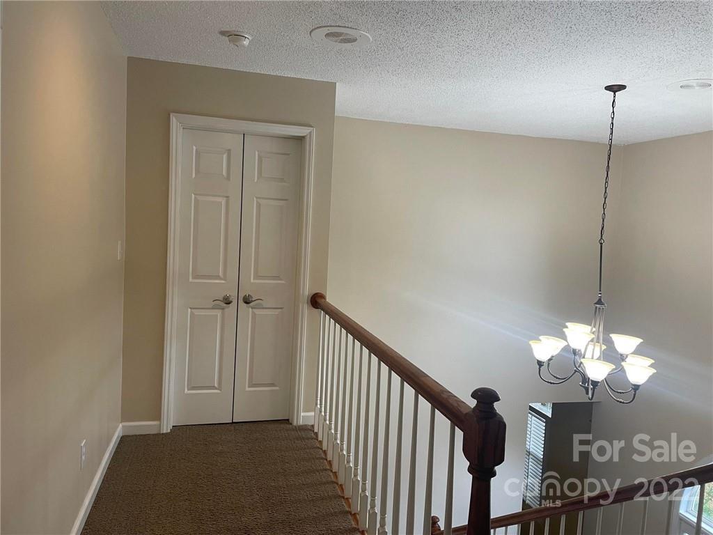 1014 Briarcliff Road Mooresville, NC 28115 - Photo 15 of 27 a view of a hallway with a chandelier