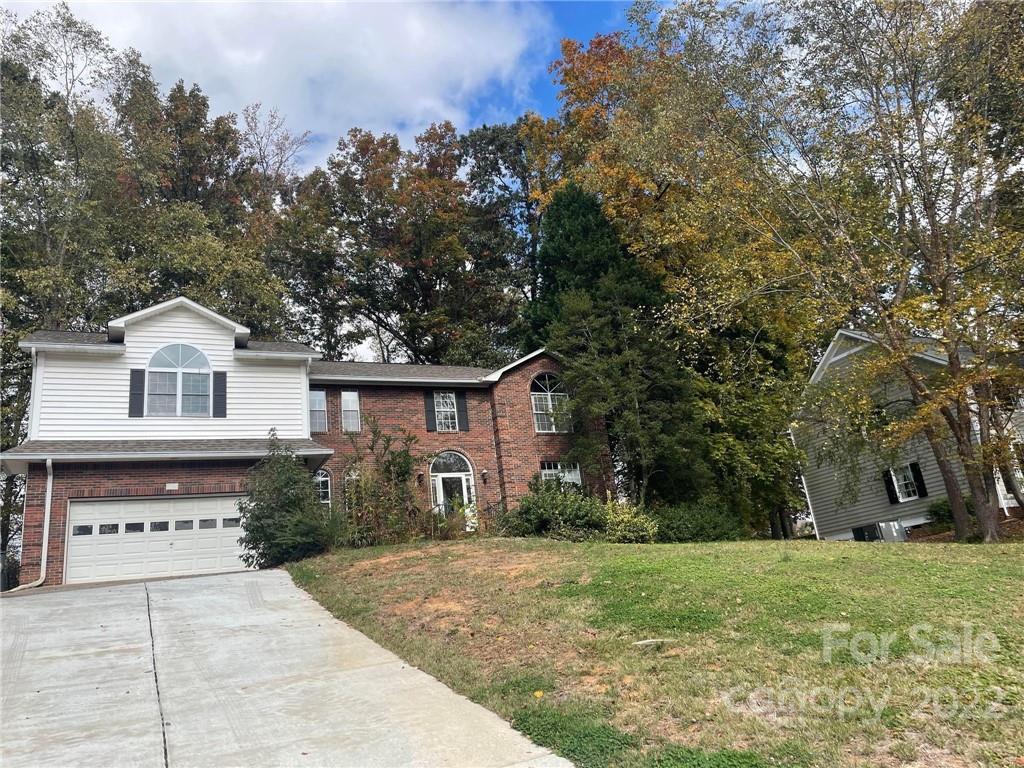 1014 Briarcliff Road Mooresville, NC 28115 - Photo 2 of 27 a view of a yard in front of a house with large trees