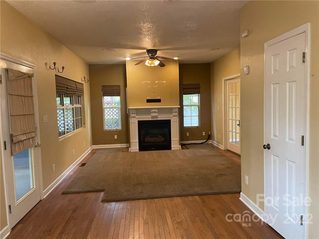 1014 Briarcliff Road Mooresville, NC 28115 - Photo 5 of 27 an empty room with windows and fireplace
